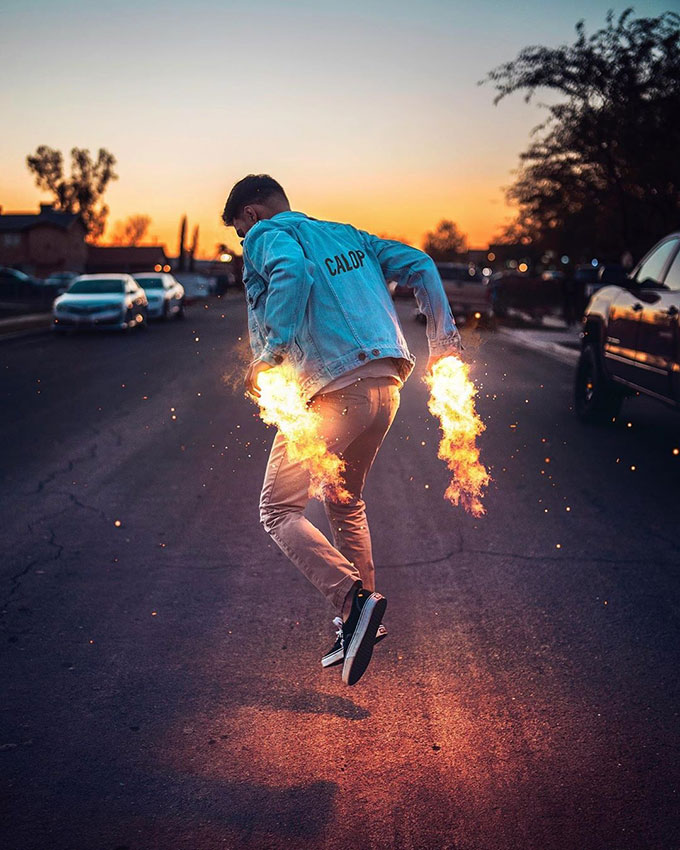 Man with fire hands as jetpack